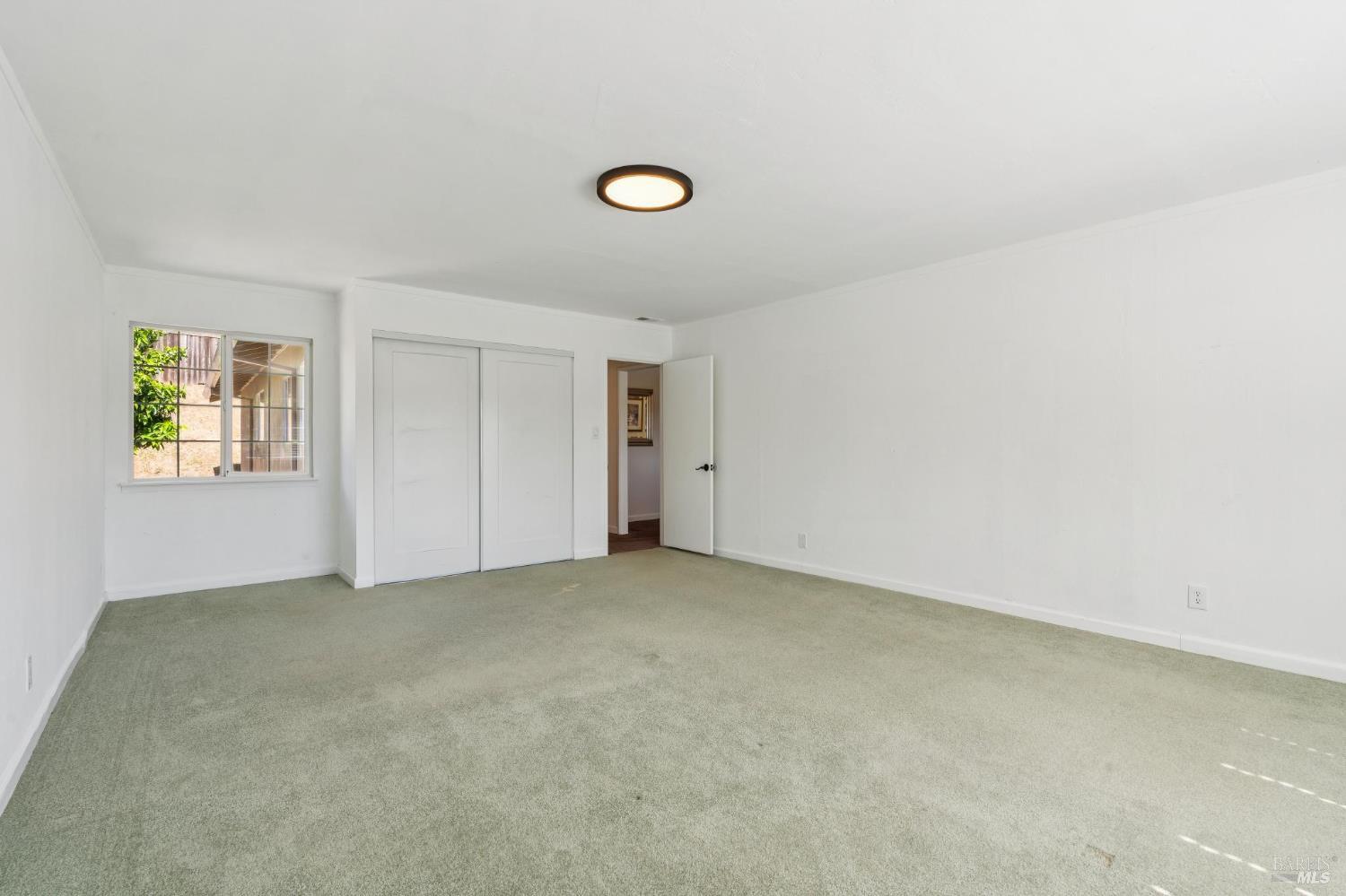 546 Pinewood Drive San Rafael, CA 94903 - Photo 21 of 52 an empty room with windows and closet