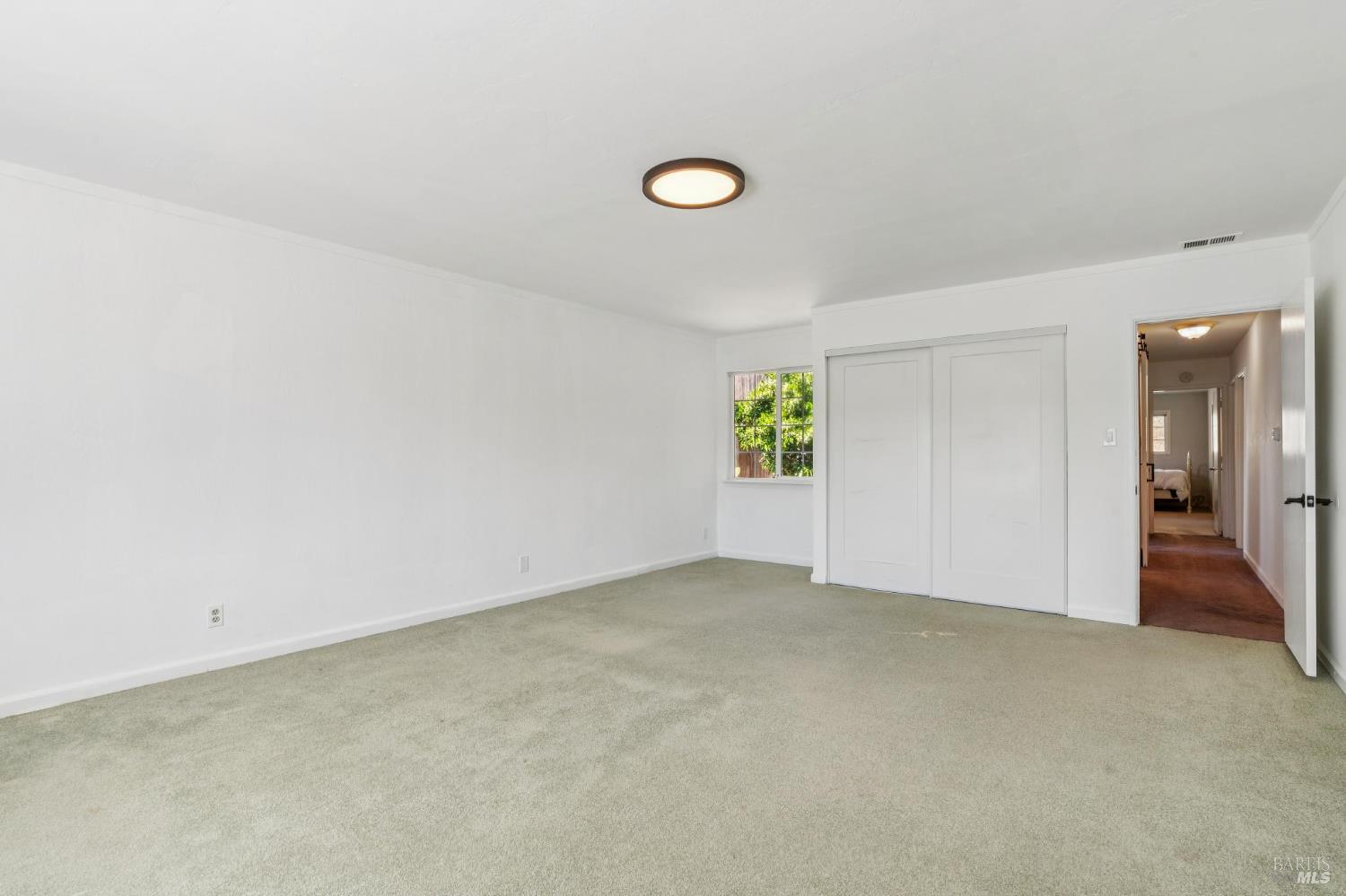 546 Pinewood Drive San Rafael, CA 94903 - Photo 23 of 52 an empty room with windows and entrance to other room