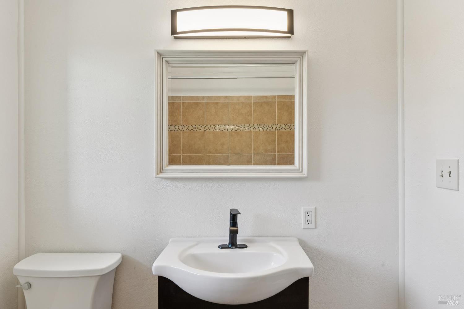 546 Pinewood Drive San Rafael, CA 94903 - Photo 26 of 52 a bathroom with a sink a toilet and a mirror