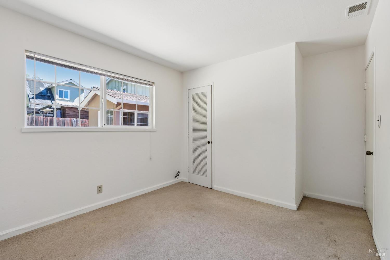 546 Pinewood Drive San Rafael, CA 94903 - Photo 30 of 52 an empty room with windows and wall painting