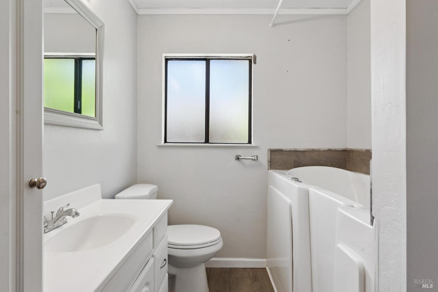 546 Pinewood Drive San Rafael, CA 94903 - Photo 31 of 52 a bathroom with a sink a toilet and mirror