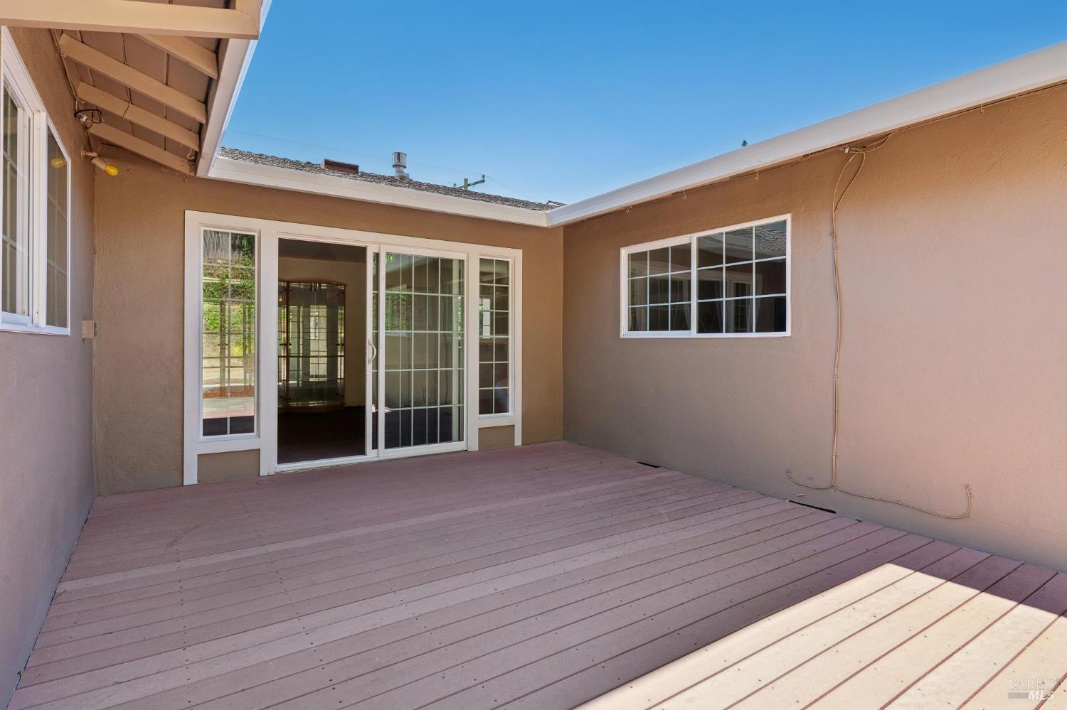 546 Pinewood Drive San Rafael, CA 94903 - Photo 43 of 52 a view of an empty room with wooden floor and windows