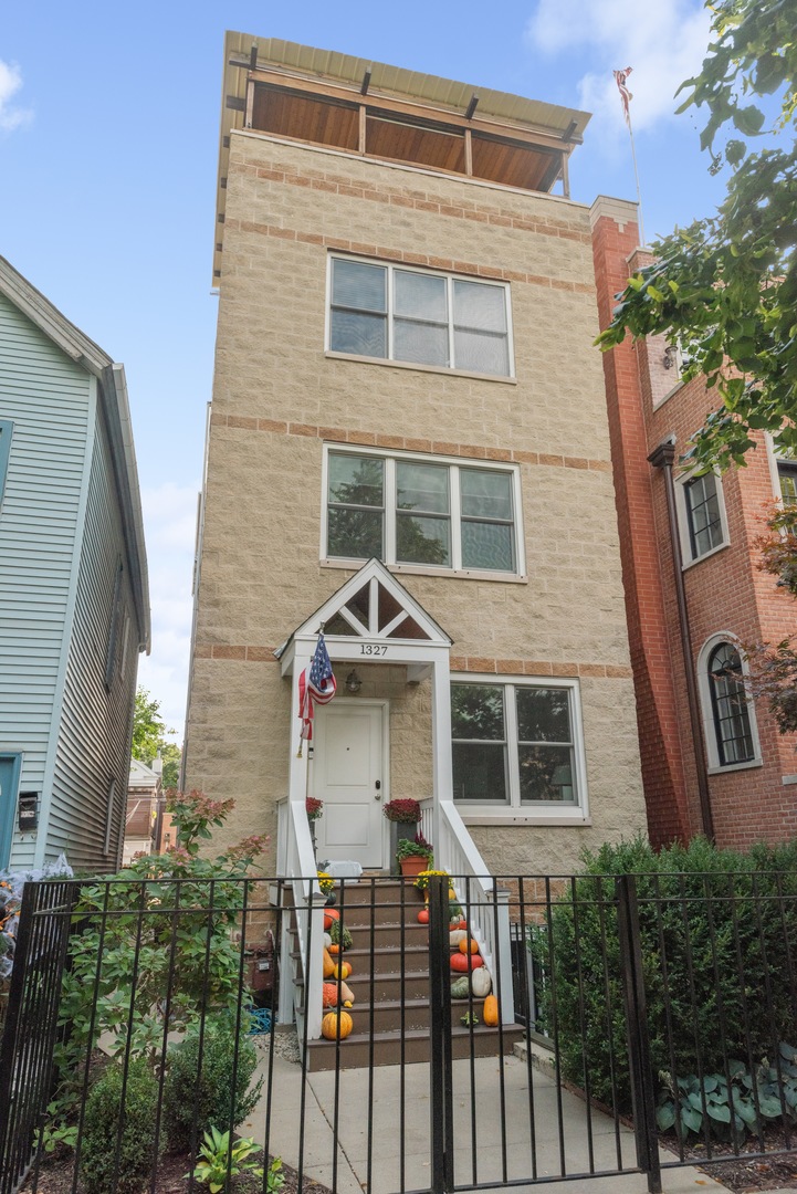 1327 West Roscoe Street, Unit 2 Chicago, IL 60657 - Photo 1 of 32 a front view of a house
