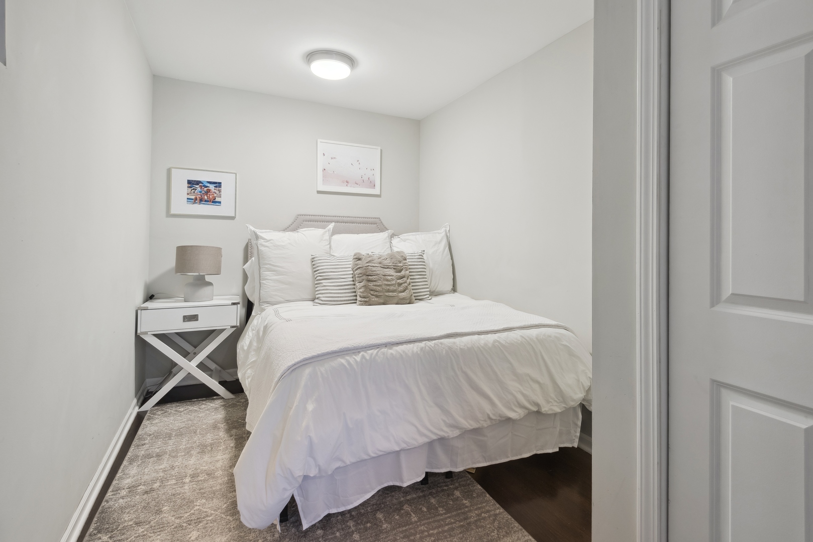 1327 West Roscoe Street, Unit 2 Chicago, IL 60657 - Photo 19 of 32 a bedroom with a bed and a table