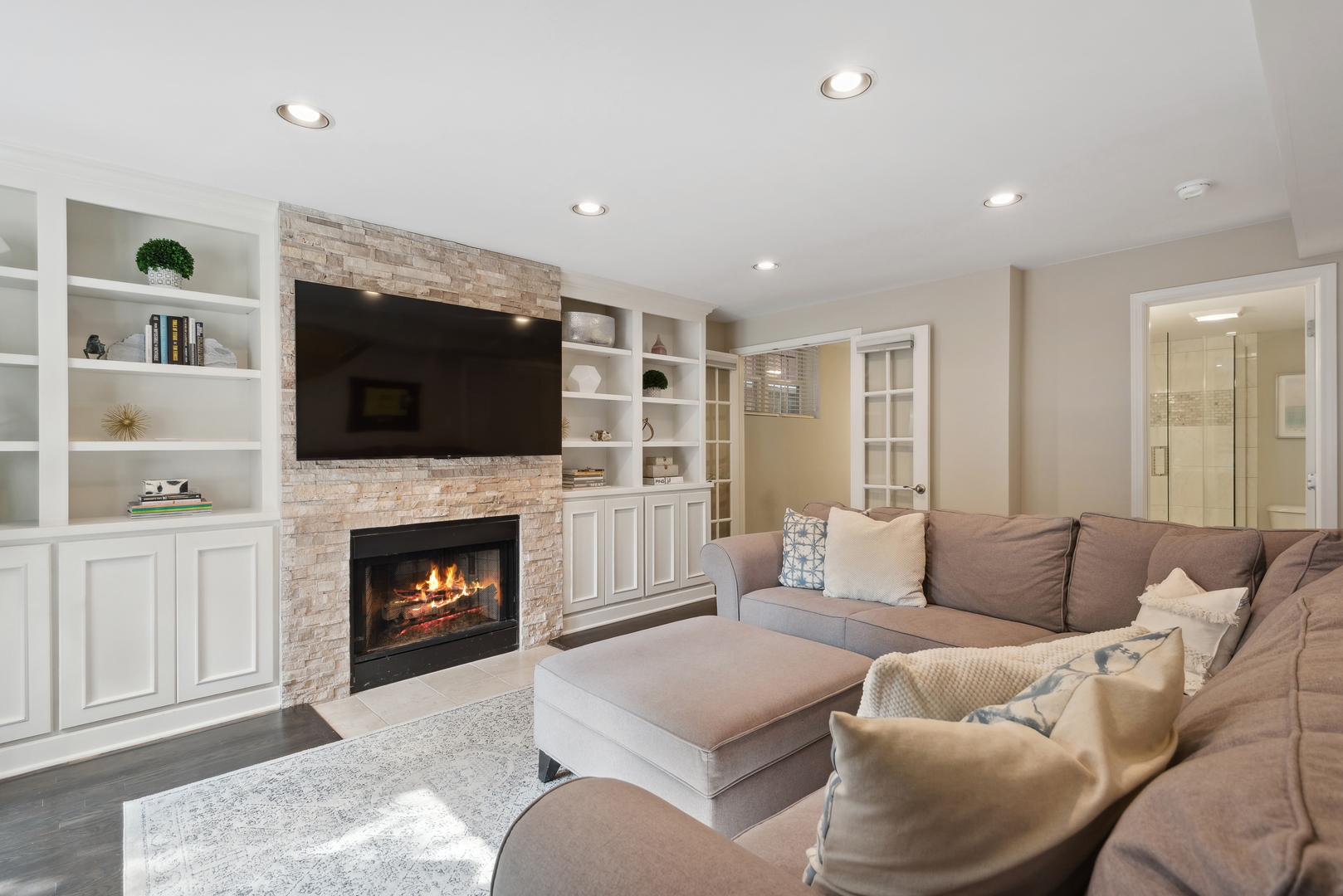 1327 West Roscoe Street, Unit 2 Chicago, IL 60657 - Photo 20 of 32 a living room with furniture flat screen tv and a fireplace