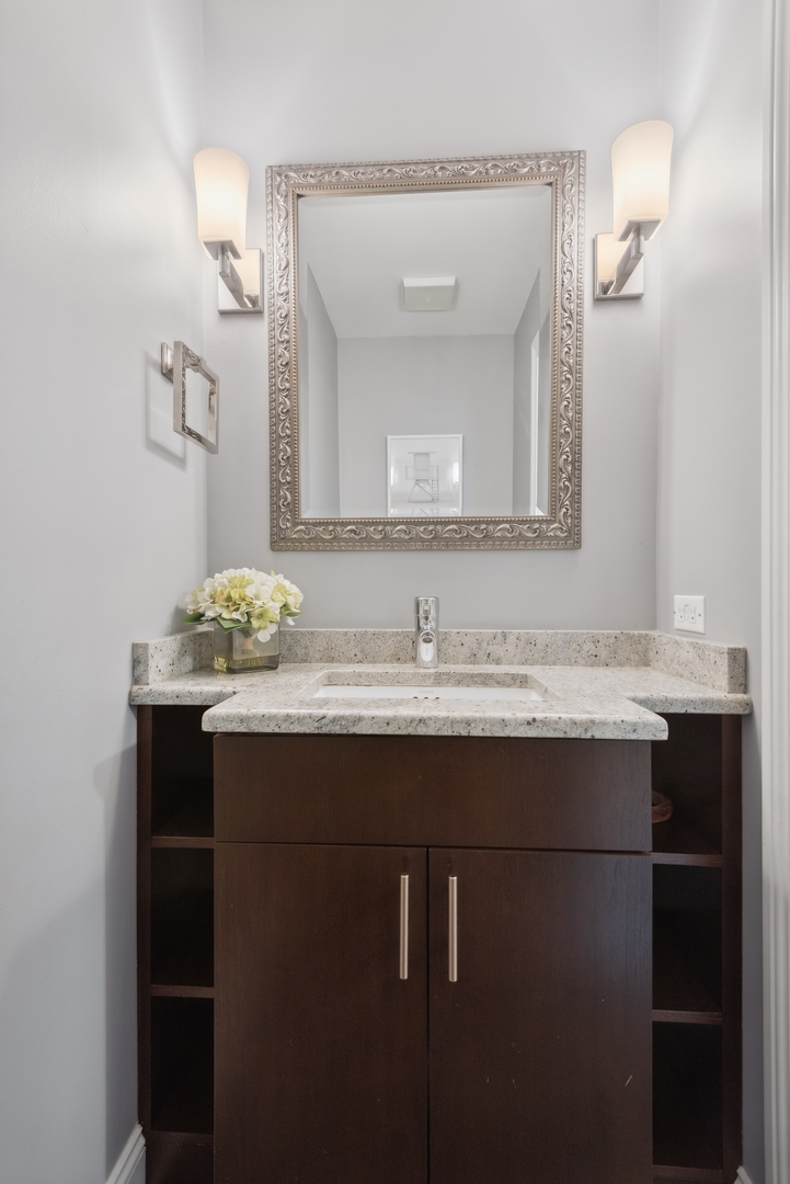 1327 West Roscoe Street, Unit 2 Chicago, IL 60657 - Photo 22 of 32 a bathroom with a sink and a mirror
