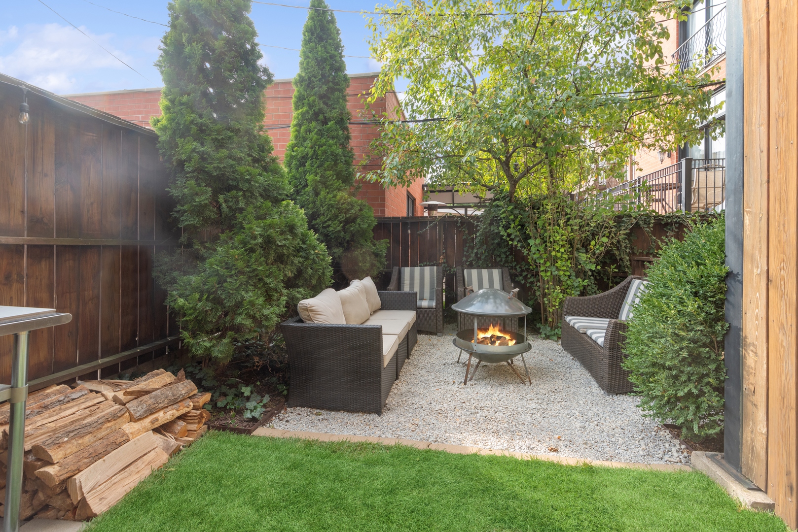 1327 West Roscoe Street, Unit 2 Chicago, IL 60657 - Photo 28 of 32 a view of a backyard with couches table and chairs and potted plants
