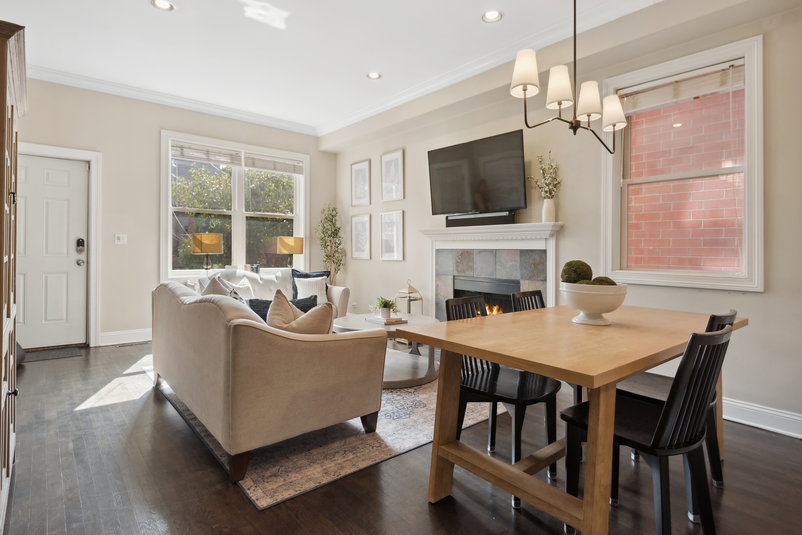 1327 West Roscoe Street, Unit 2 Chicago, IL 60657 - Photo 5 of 32 a living room with fireplace furniture and a flat screen tv