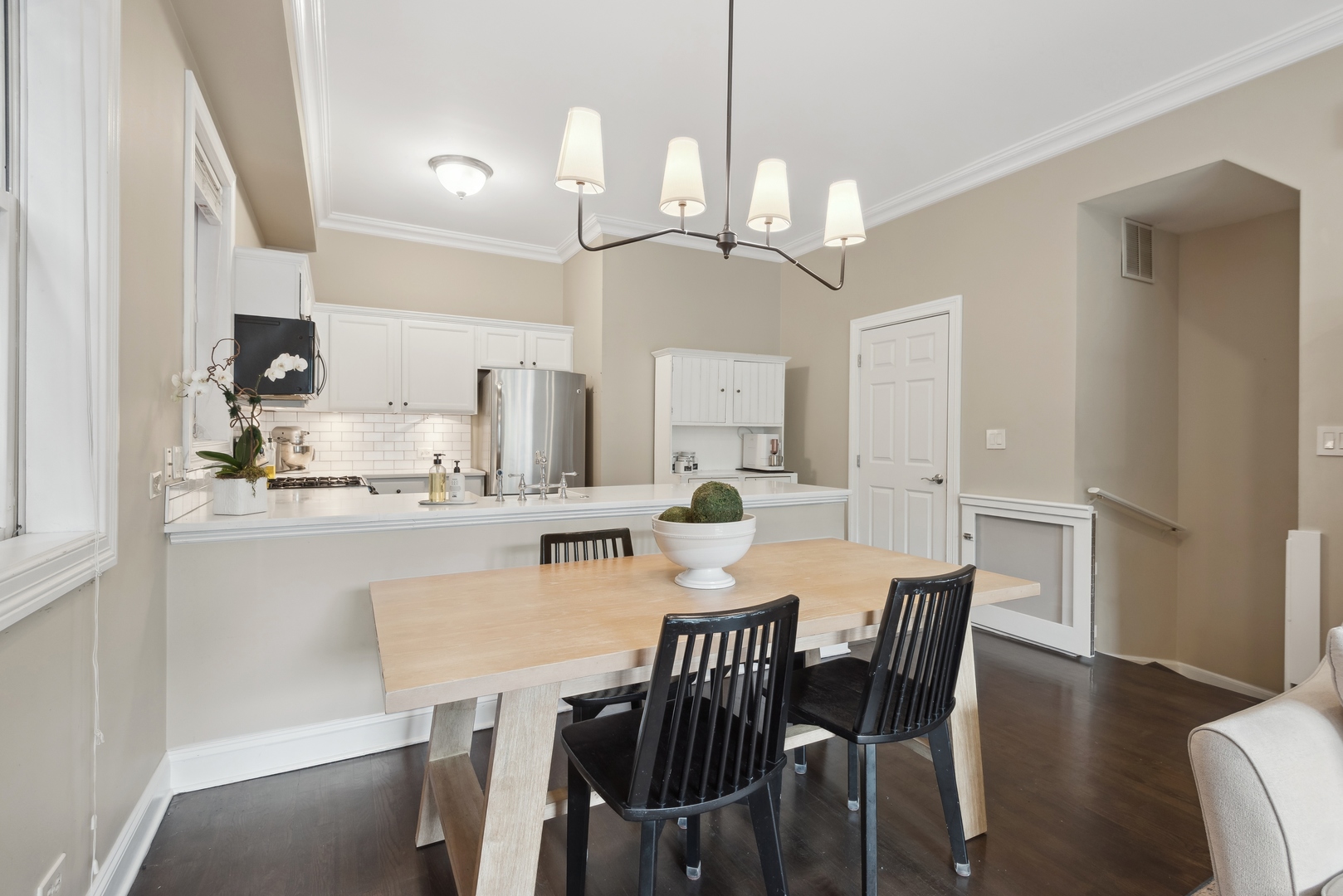 1327 West Roscoe Street, Unit 2 Chicago, IL 60657 - Photo 6 of 32 a view of a dining room with furniture a chandelier and wooden floor