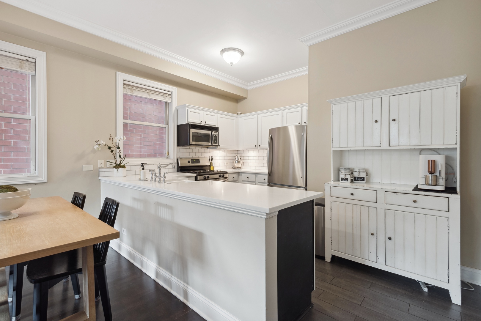 1327 West Roscoe Street, Unit 2 Chicago, IL 60657 - Photo 8 of 32 a kitchen with stainless steel appliances cabinets a sink and a refrigerator