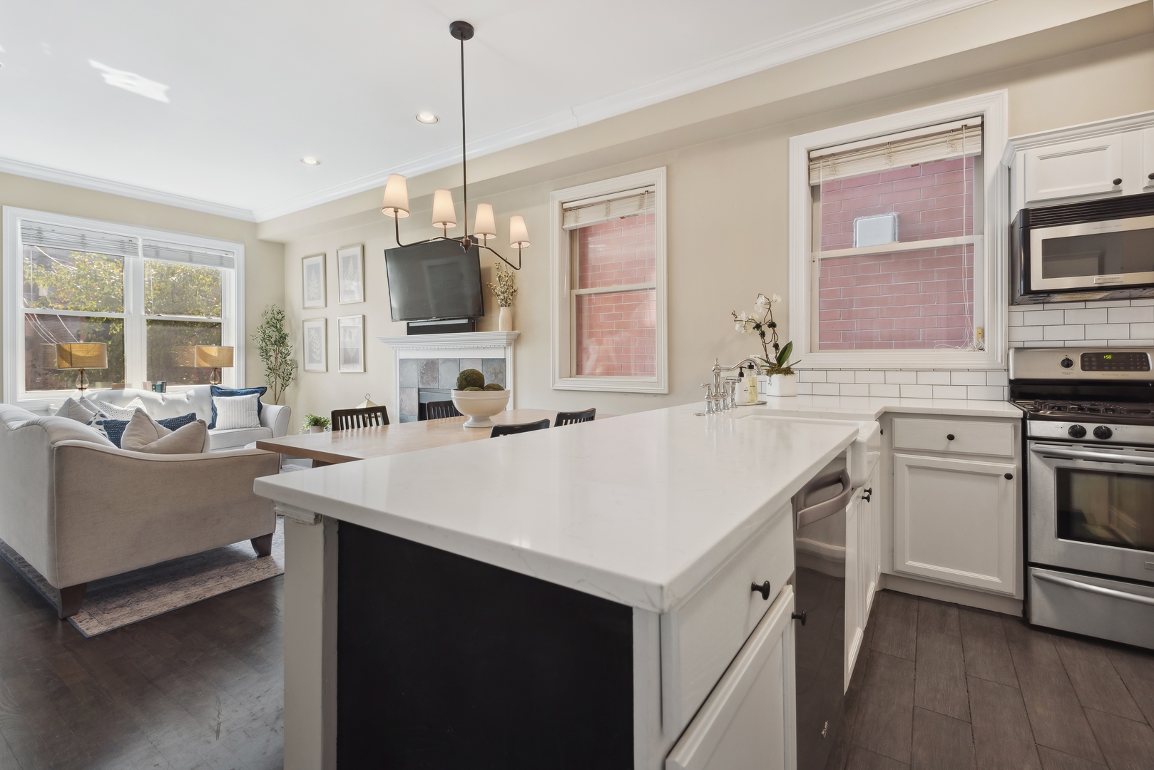 1327 West Roscoe Street, Unit 2 Chicago, IL 60657 - Photo 9 of 32 a kitchen with a sink stove and microwave