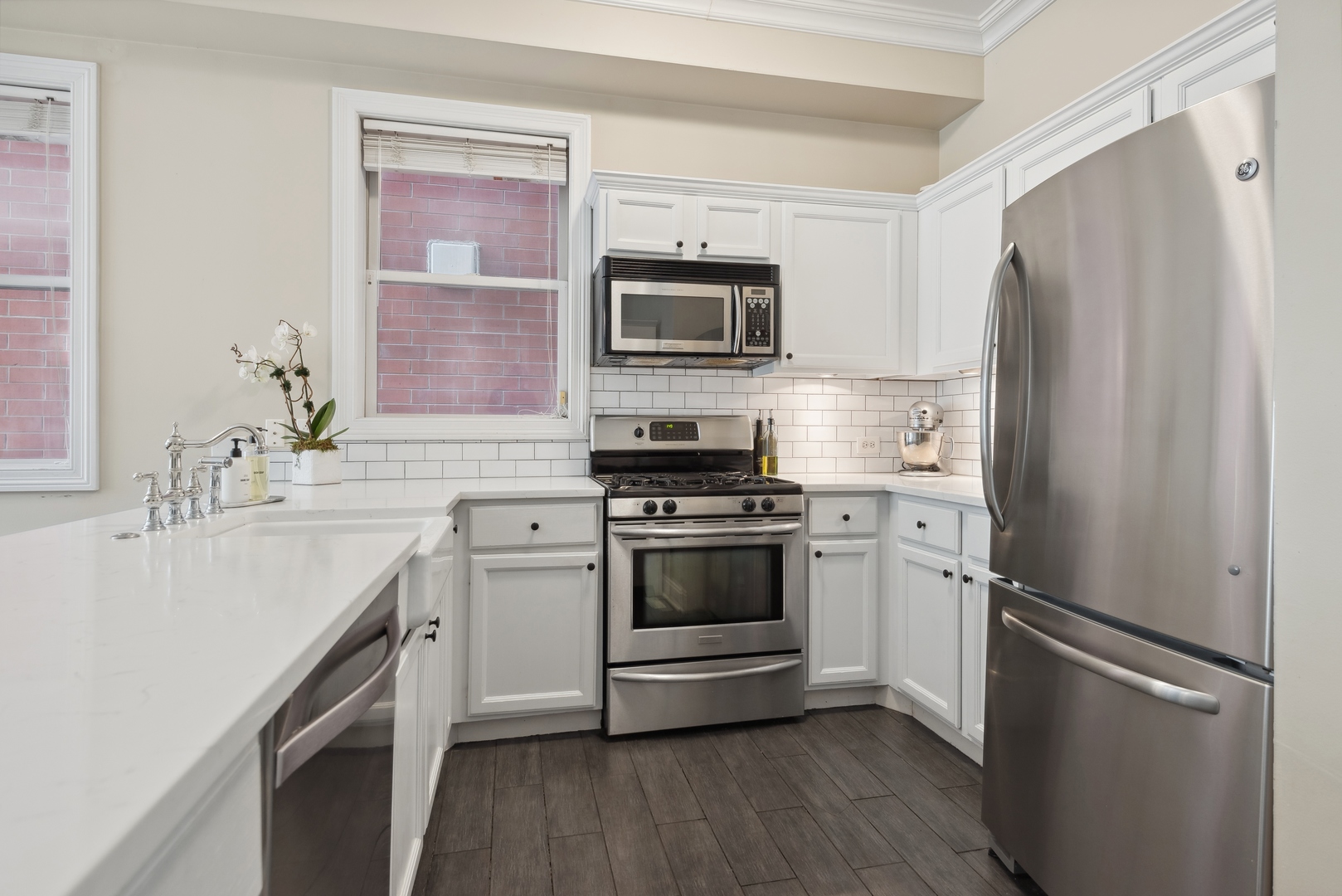 1327 West Roscoe Street, Unit 2 Chicago, IL 60657 - Photo 10 of 32 a kitchen with a refrigerator stove and sink