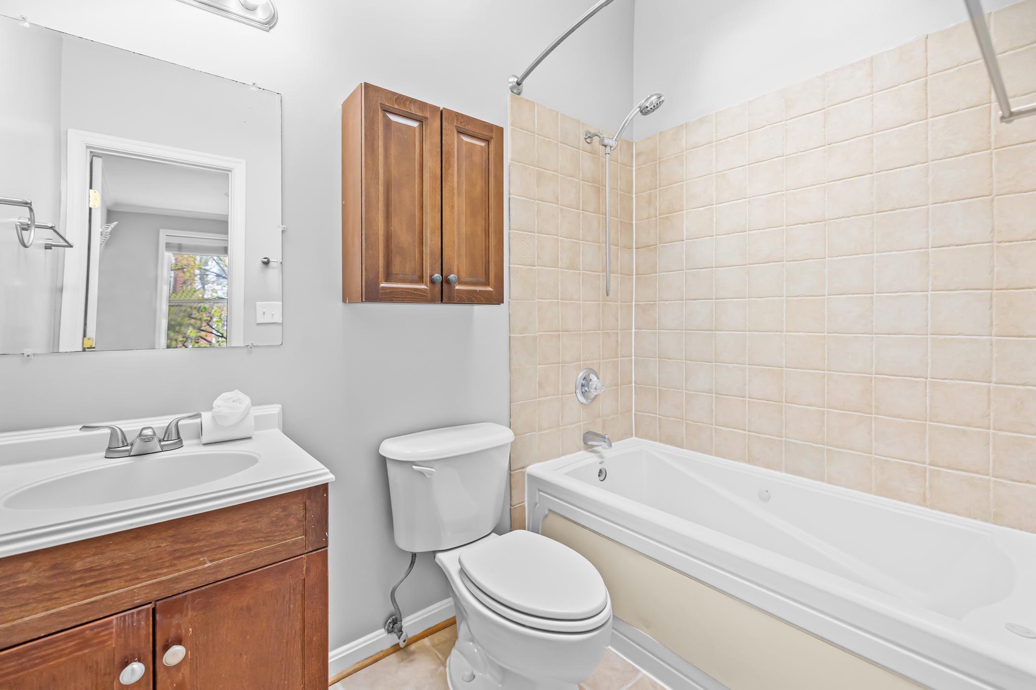 773 Kenyon Street Northwest Washington, DC 20010 - Photo 12 of 17 a bathroom with a toilet a sink and bathtub
