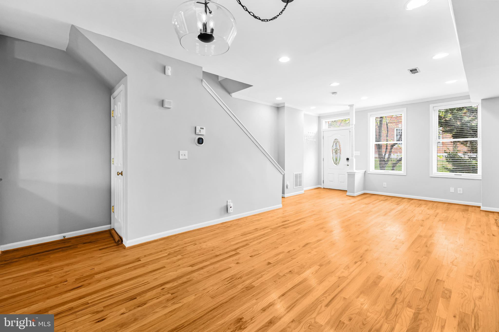 773 Kenyon Street Northwest Washington, DC 20010 - Photo 6 of 17 a view of empty room with wooden floor and fan