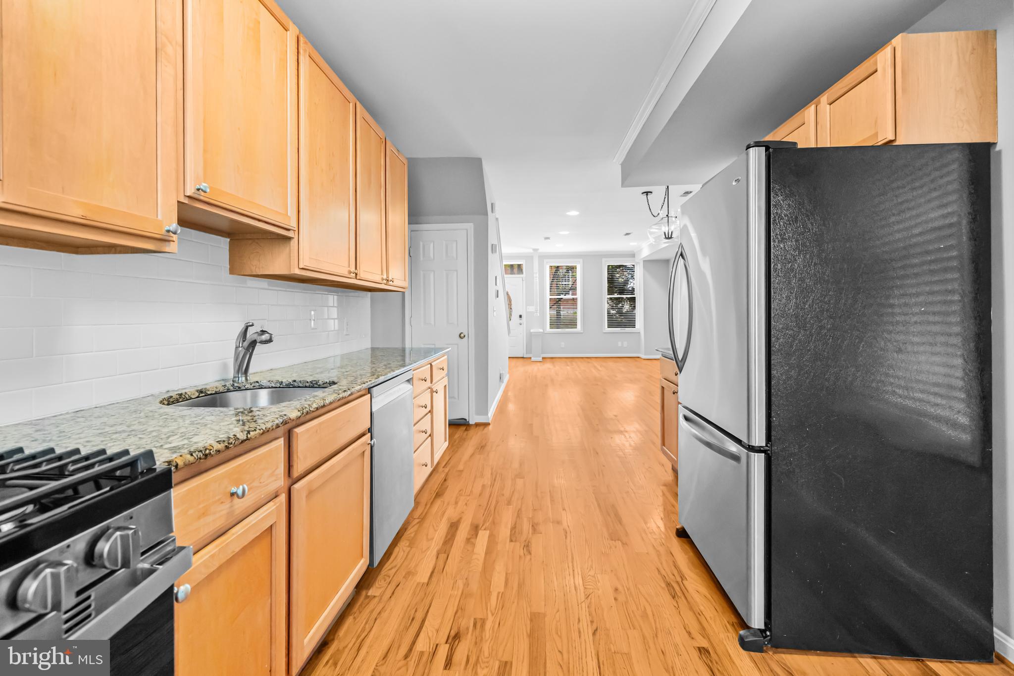 773 Kenyon Street Northwest Washington, DC 20010 - Photo 9 of 17 a kitchen with stainless steel appliances granite countertop a refrigerator a stove and a sink
