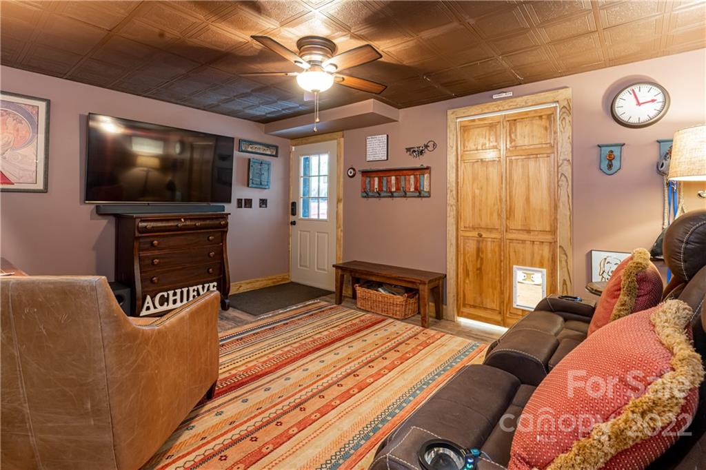 29 Spring Lane Fairview, NC 28730 - Photo 23 of 43 a living room with furniture and a flat screen tv