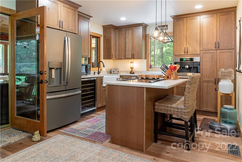 29 Spring Lane Fairview, NC 28730 - Photo 5 of 43 a kitchen with stainless steel appliances a stove a sink refrigerator and a refrigerator
