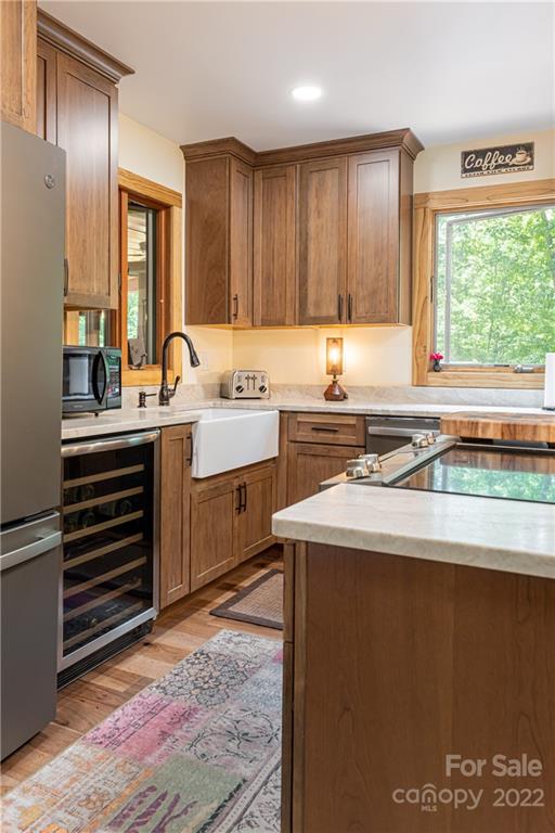 29 Spring Lane Fairview, NC 28730 - Photo 7 of 43 a kitchen with a sink stove and cabinets