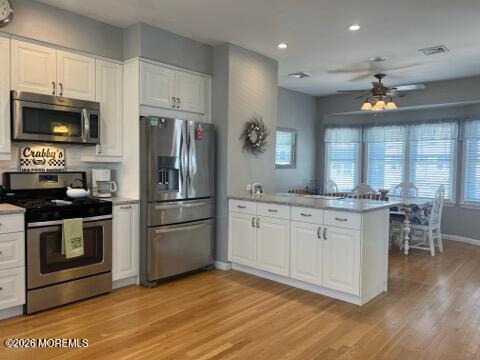 119 Randall Avenue, Unit A Point Pleasant Beach, NJ 08742 - Photo 11 of 27 a kitchen with granite countertop a stove a sink and a refrigerator