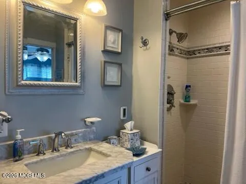 a bathroom with a granite countertop sink a light fixture and a mirror