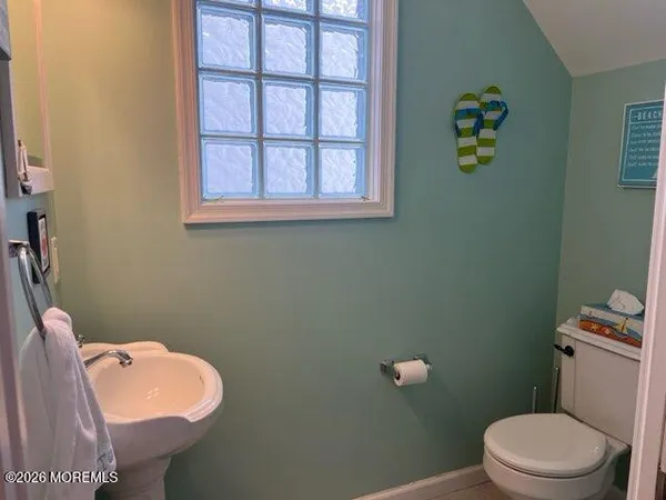 a white toilet sitting next to a bathroom sink