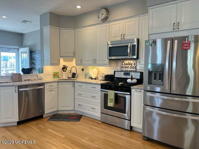 119 Randall Avenue, Unit A Point Pleasant Beach, NJ 08742 - Photo 10 of 27 a kitchen with stainless steel appliances a stove a sink and a refrigerator
