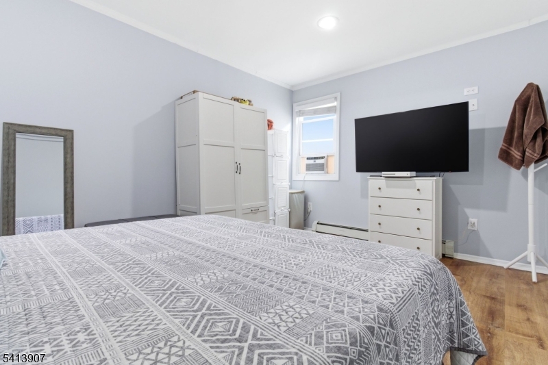 32 Cedar Avenue Elizabeth, NJ 07202 - Photo 14 of 32 a bedroom with a bed and a flat screen tv