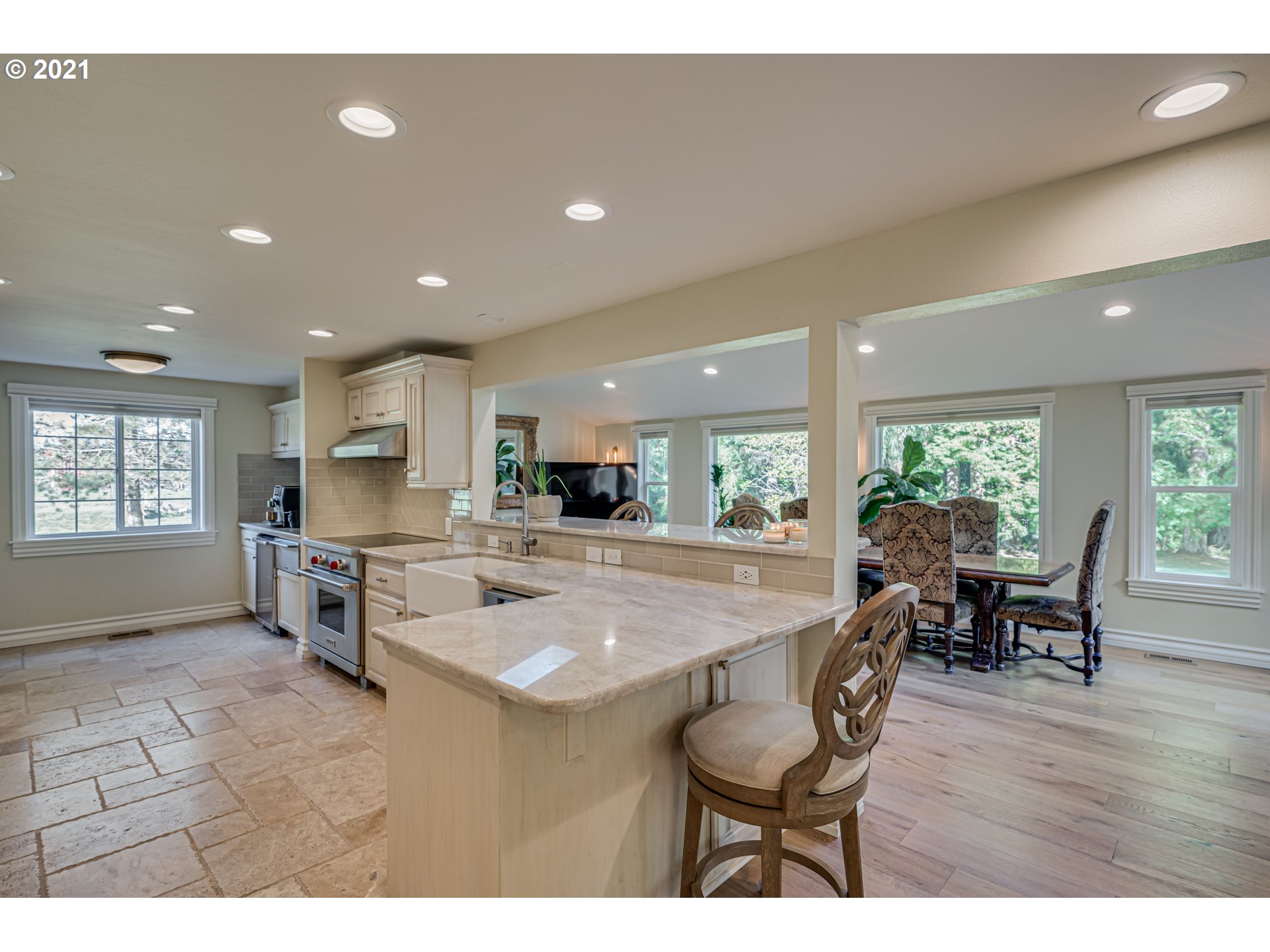29010 Northwest 2nd Avenue Ridgefield, WA 98642 - Photo 9 of 32 a open kitchen with stainless steel appliances granite countertop a stove top oven a sink dishwasher a dining table and chairs with wooden floor