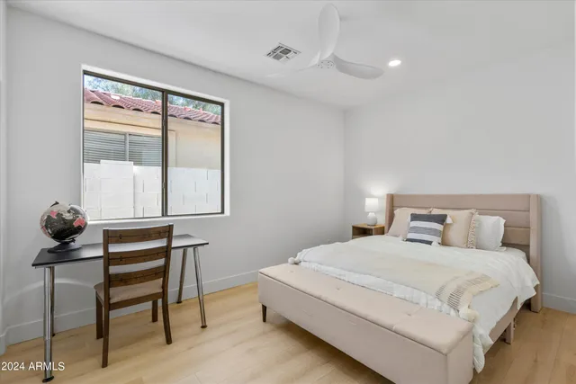 a bedroom with a bed and a window