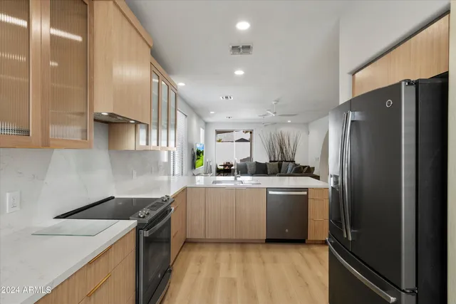 a kitchen with white cabinets and stainless steel appliances