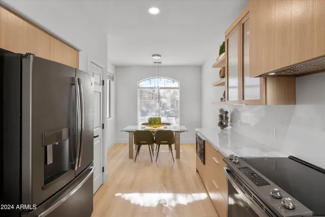 a large white kitchen with a large window