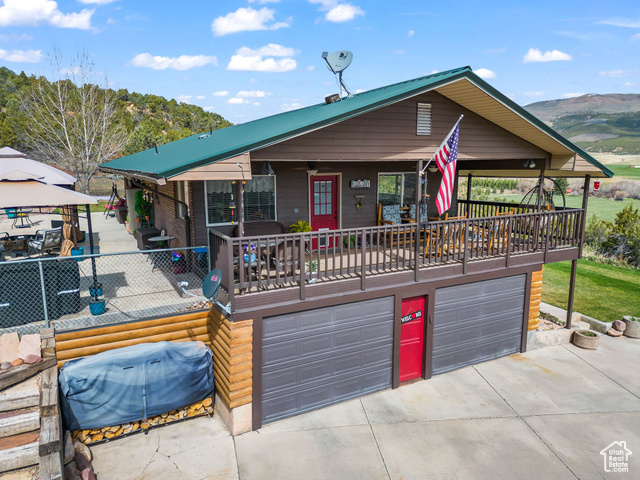 6407 North Dry Frk Cyn Road West Vernal, UT 84078 - Photo 6 of 48 View of front of home with driveway, a garage, a mountain view, and a gazebo
