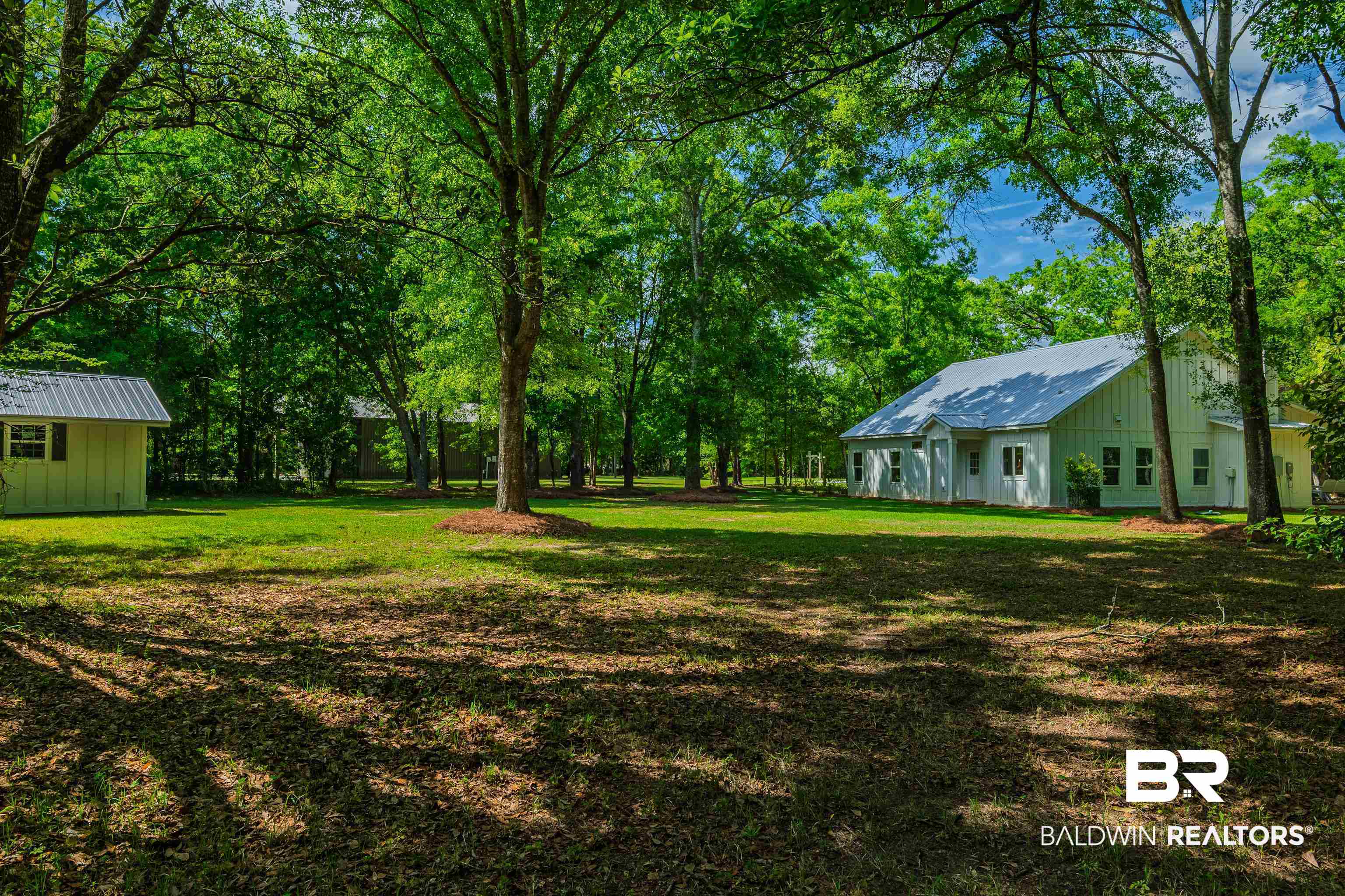 19121 Boothe Road Fairhope, AL 36532 - Photo 33 of 41 View of grassy yard with view of wooded area and an outbuilding