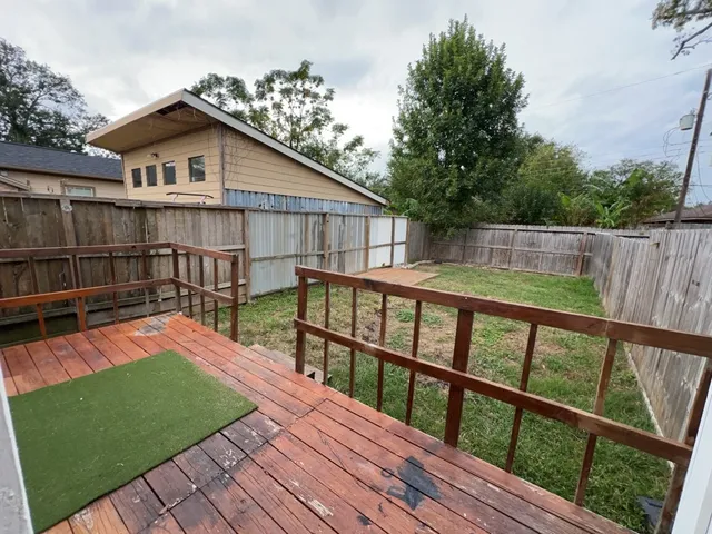 a view of a wooden deck with a yard