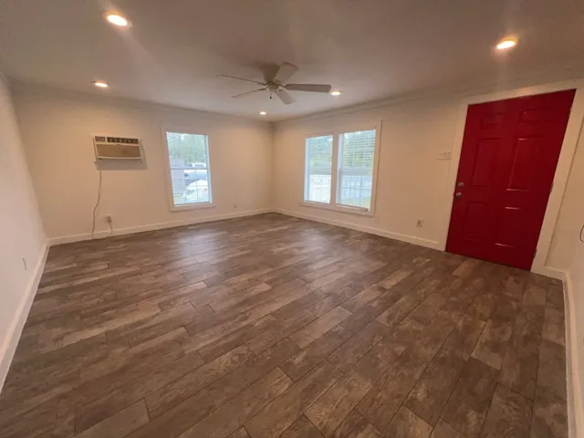 an empty room with windows and closet