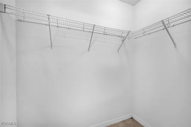 an empty room with a ceiling fan and a window