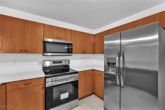 a kitchen with a refrigerator stove and microwave