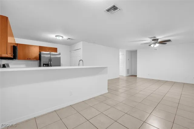 a view of a kitchen with a sink and chandelier