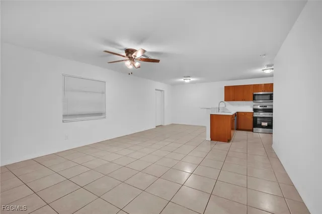 a view of kitchen with furniture and a ceiling fan