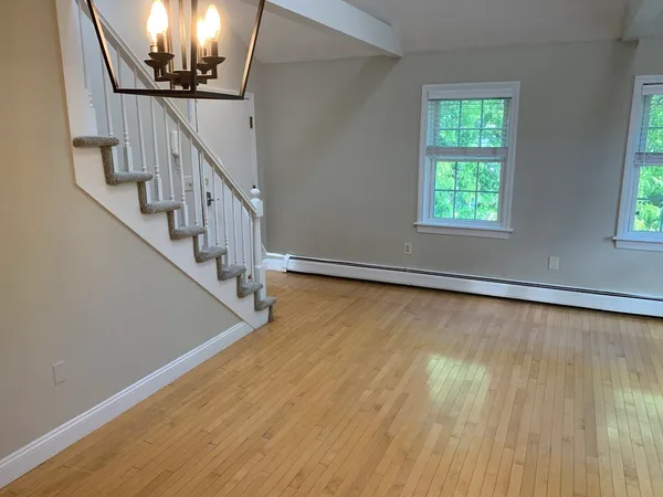 a view of an entryway with wooden floor