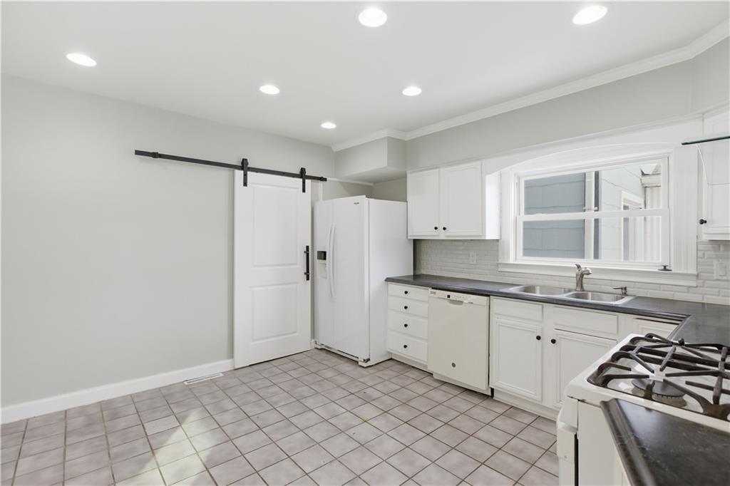 208 Boden Avenue Carnegie, PA 15106 - Photo 11 of 26 a kitchen with granite countertop a sink stove and refrigerator