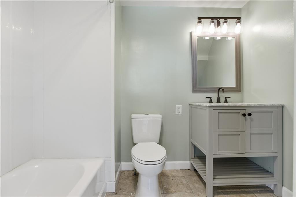 208 Boden Avenue Carnegie, PA 15106 - Photo 12 of 26 a bathroom with a toilet a sink and mirror