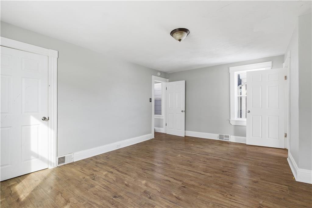 208 Boden Avenue Carnegie, PA 15106 - Photo 20 of 26 a view of an empty room with wooden floor and a window