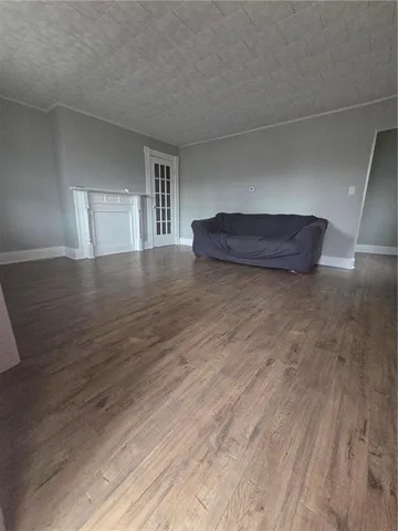 a view of a room with wooden floor and window
