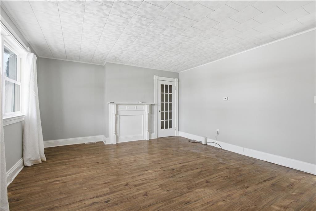 208 Boden Avenue Carnegie, PA 15106 - Photo 6 of 26 a view of an empty room with wooden floor and a window
