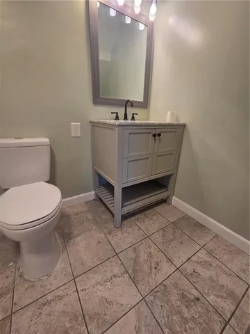 a bathroom with a sink toilet and mirror