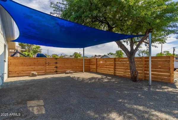 a view of a backyard with wooden fence