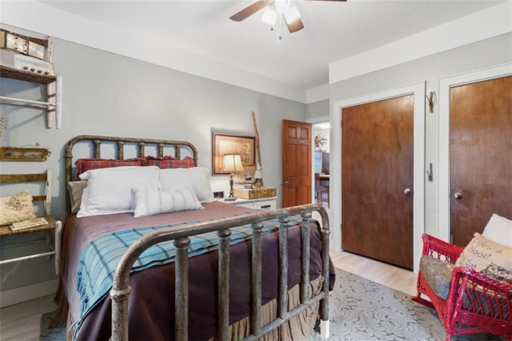219 Raven Cliff Road Talking Rock, GA 30175 - Photo 19 of 77 a bedroom with a bed and a chandelier