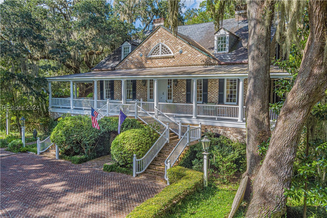 92 Dean Hall Road Seabrook, SC 29940 - Photo 4 of 99 South and North entrance elevations to the primary residence are identical; the above image is the South elevation