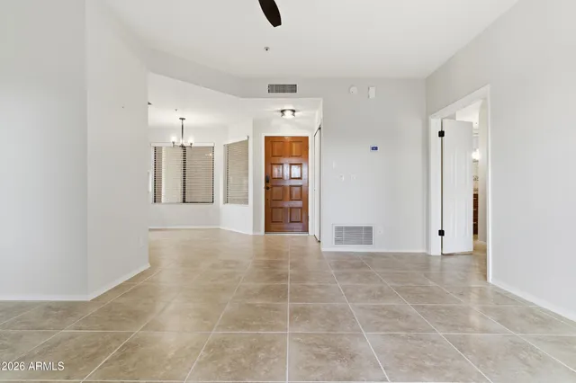 a view of an empty room with cabinet and entryway
